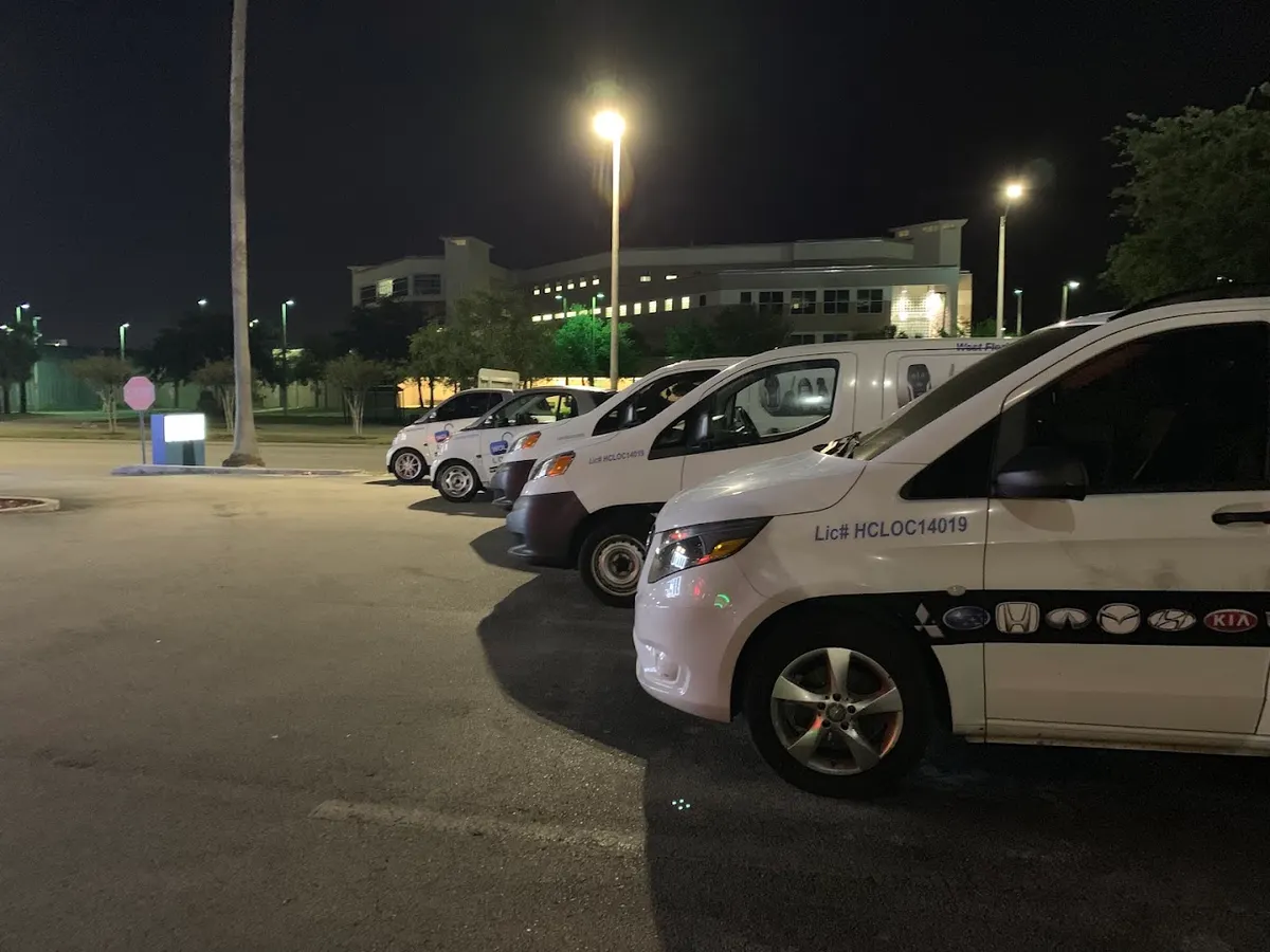 Three service vans parked outside at night