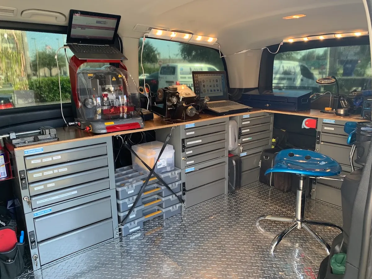 Inside a van: key cutting machine, drawers of blanks and a laptop